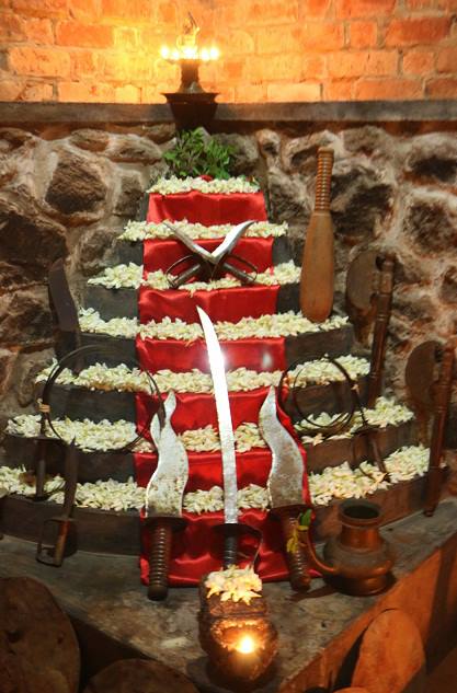 Sacred ceremonial altar at Buddha Kalari Academy with traditional Kerala decorations, oil lamps, and jasmine garlands for spiritual practice