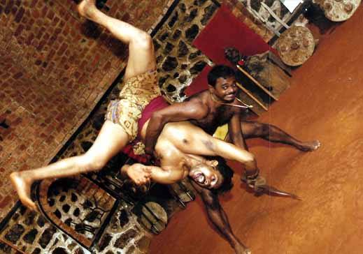 Kalaripayattu ground grappling and wrestling techniques with practitioners demonstrating traditional Kerala martial arts close combat