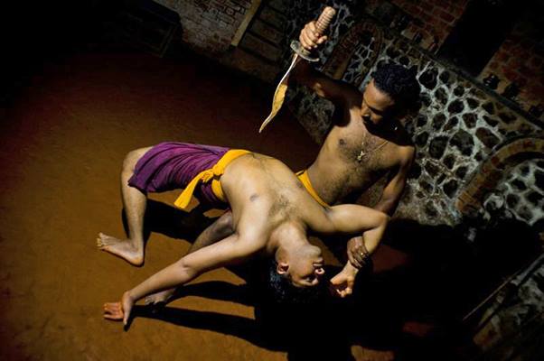 Kalaripayattu knife fighting techniques demonstration with practitioners in traditional purple attire showing blade combat skills